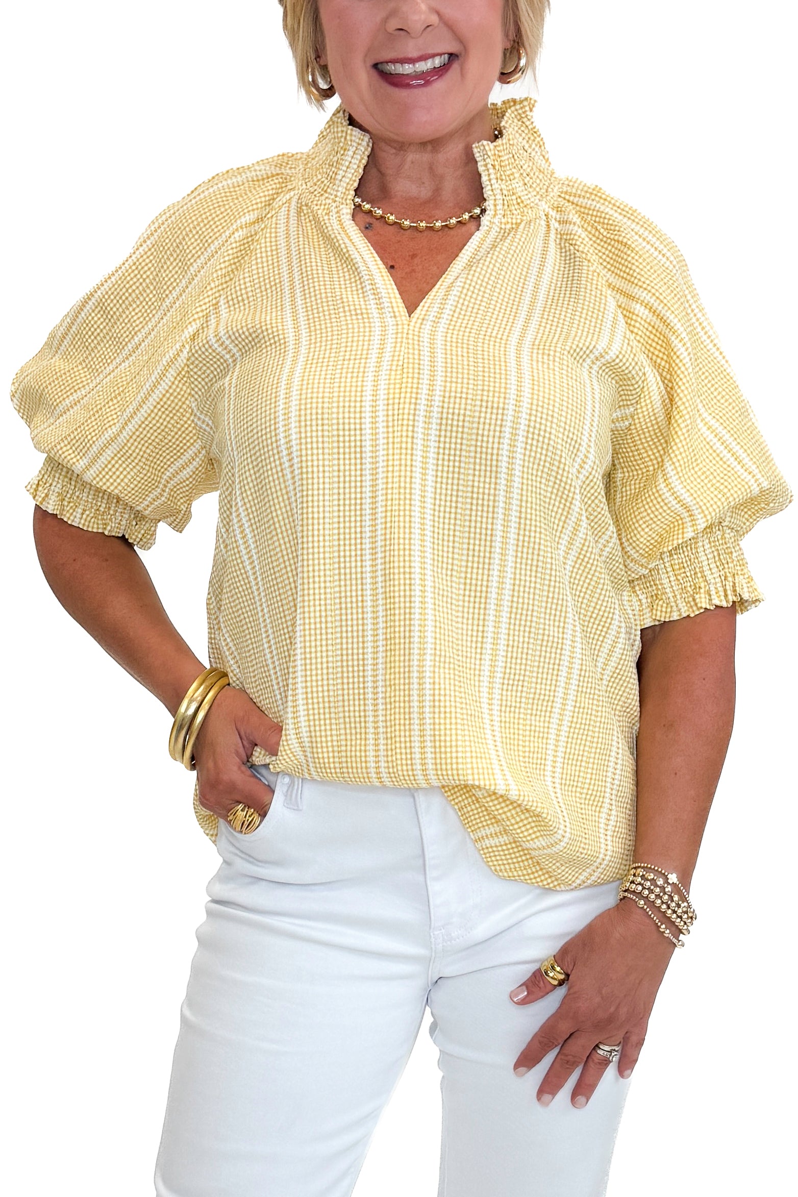 Front detail view of woman wearing Swagger Boutique’s Yellow Striped Puff Sleeve Top with jeans against white studio background.