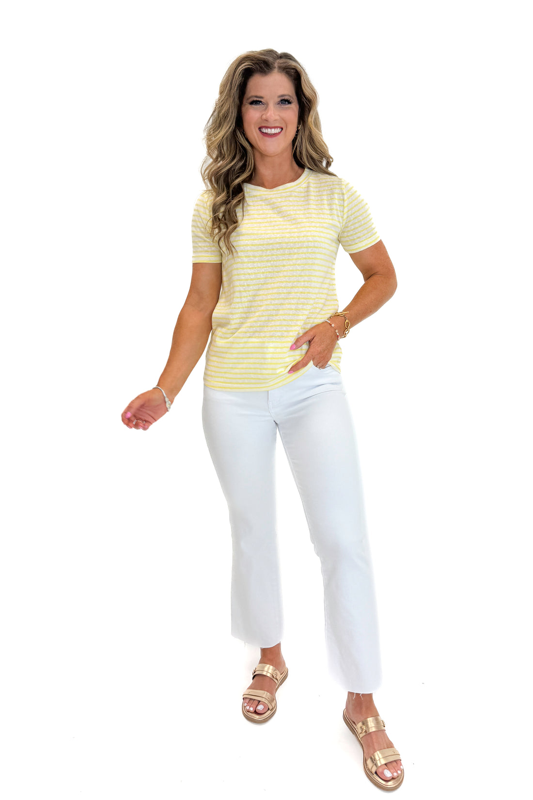 Front view of woman wearing Swagger Boutique’s Yellow Striped Tee with jeans against white studio background.