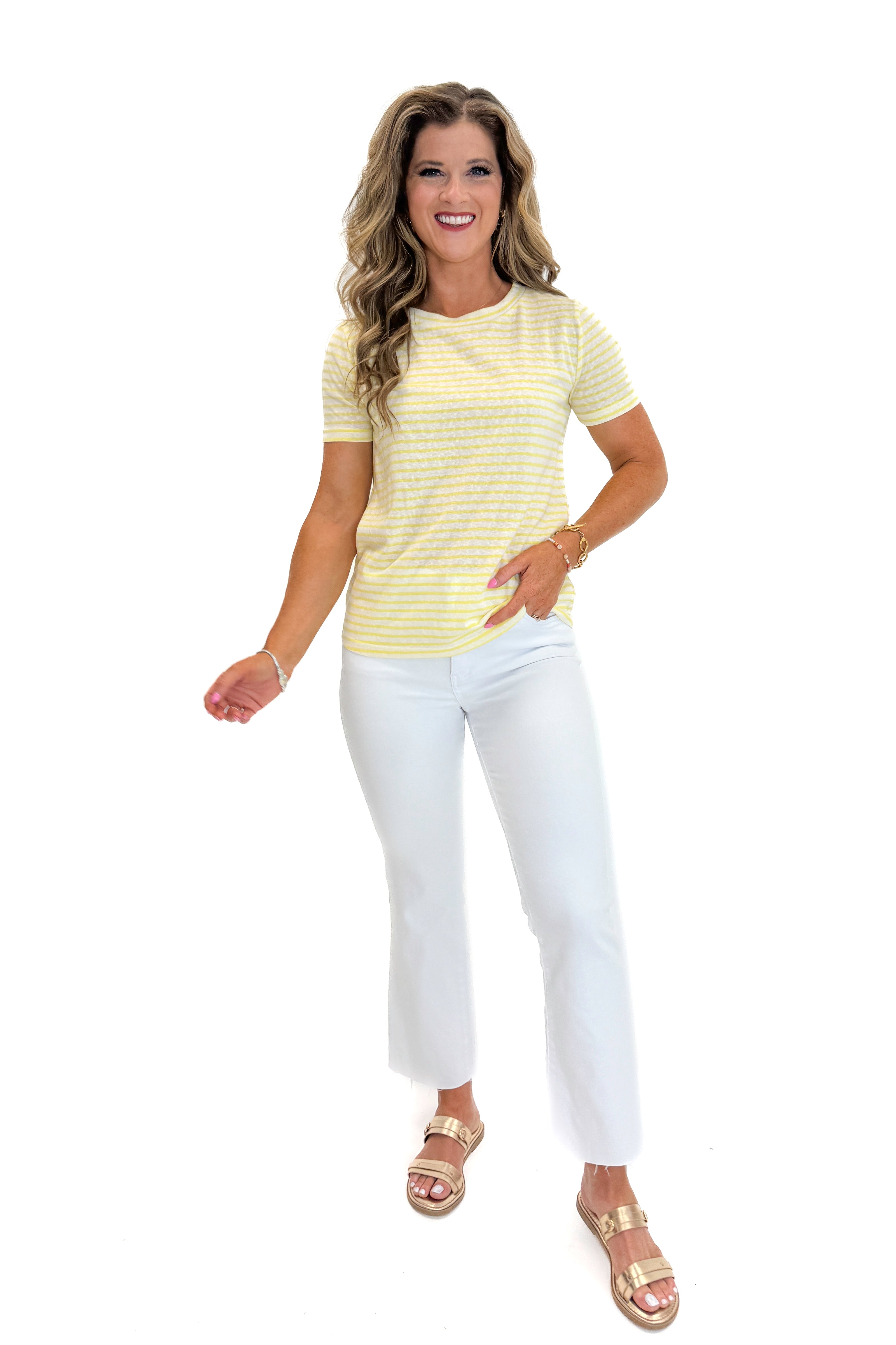 Front view of woman wearing Swagger Boutique’s Yellow Striped Tee with jeans against white studio background.