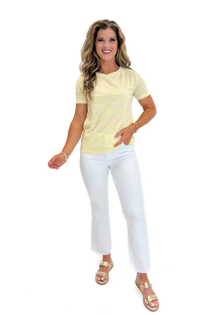 Front view of woman wearing Swagger Boutique’s Yellow Striped Tee with jeans against white studio background.