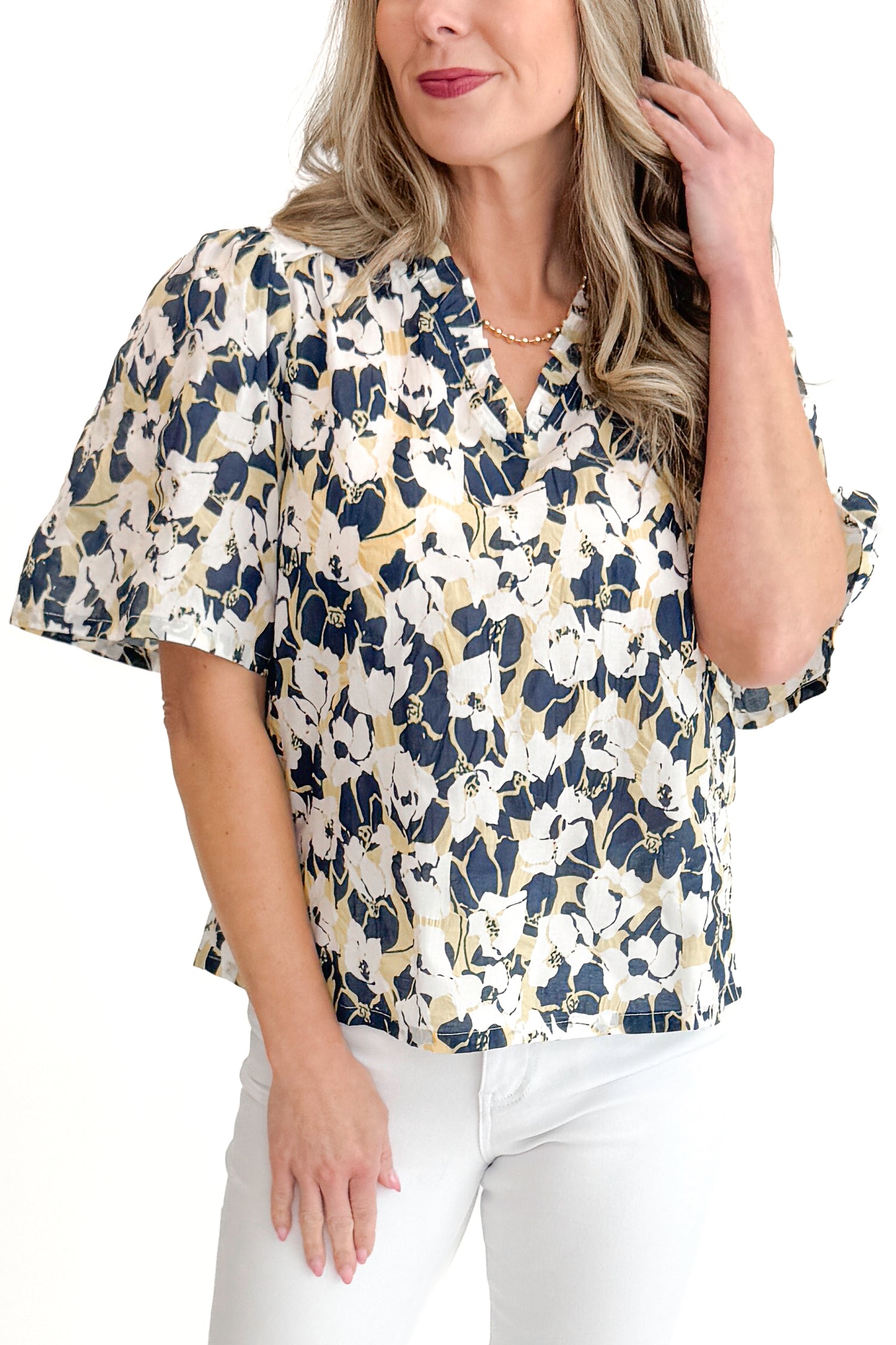Front view of woman wearing Swagger Boutique’s Yellow &amp; Navy Floral Printed Top with jeans against white studio background.
