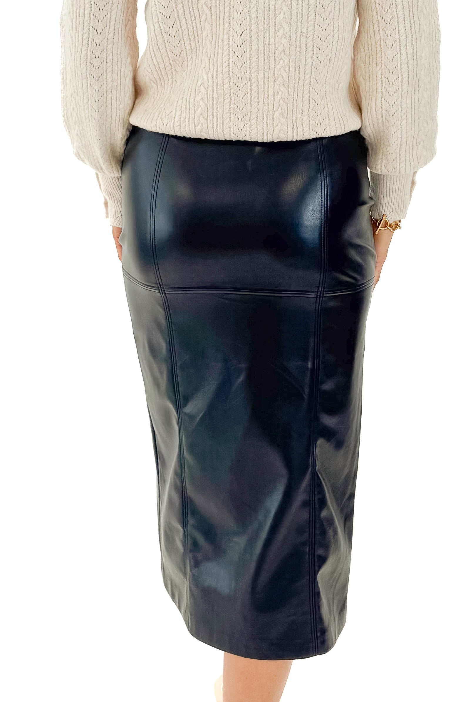 Back view of woman wearing top with Black Reine Faux Leather Skirt by Z Supply against white studio background.