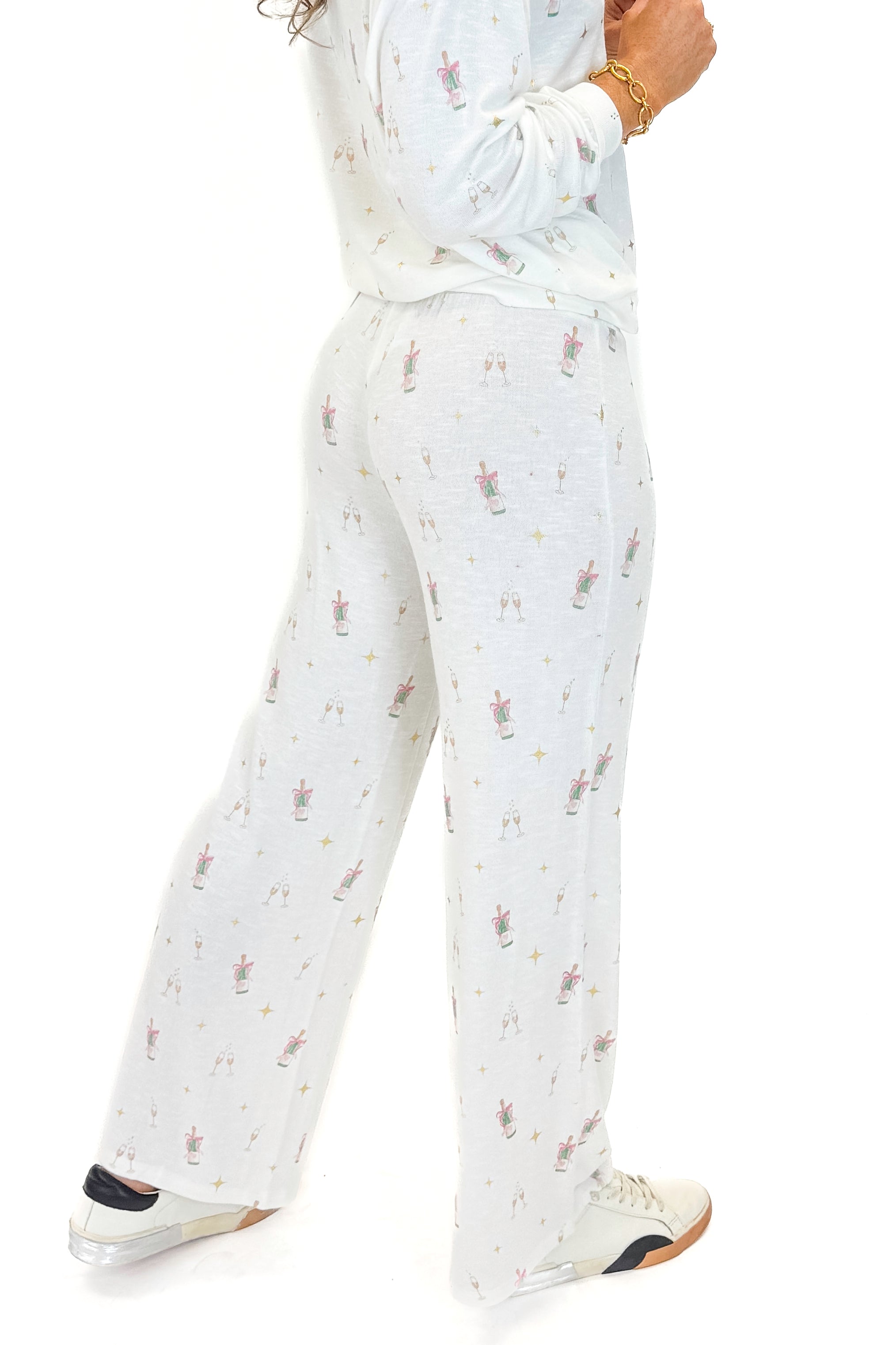 Side view of woman wearing Vanilla Ice Dawn Champagne Lounge Pants with matching top against white studio background.