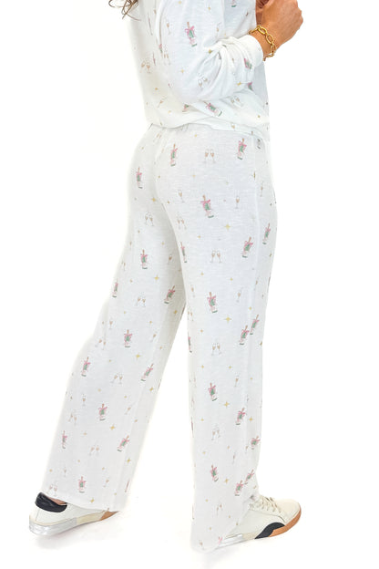 Side view of woman wearing Vanilla Ice Dawn Champagne Lounge Pants with matching top against white studio background.