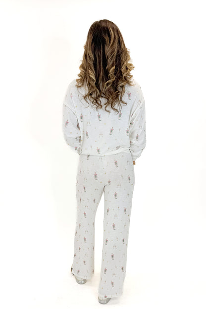Back view of woman wearing Vanilla Ice Dawn Champagne Lounge Pants with matching top against white studio background.