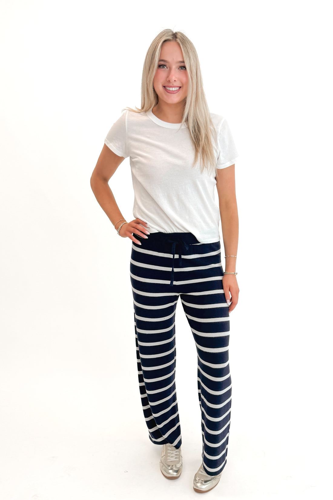 Front view of woman wearing Eclipse Overboard Stripe Pant by Z Supply with white top against white studio background.