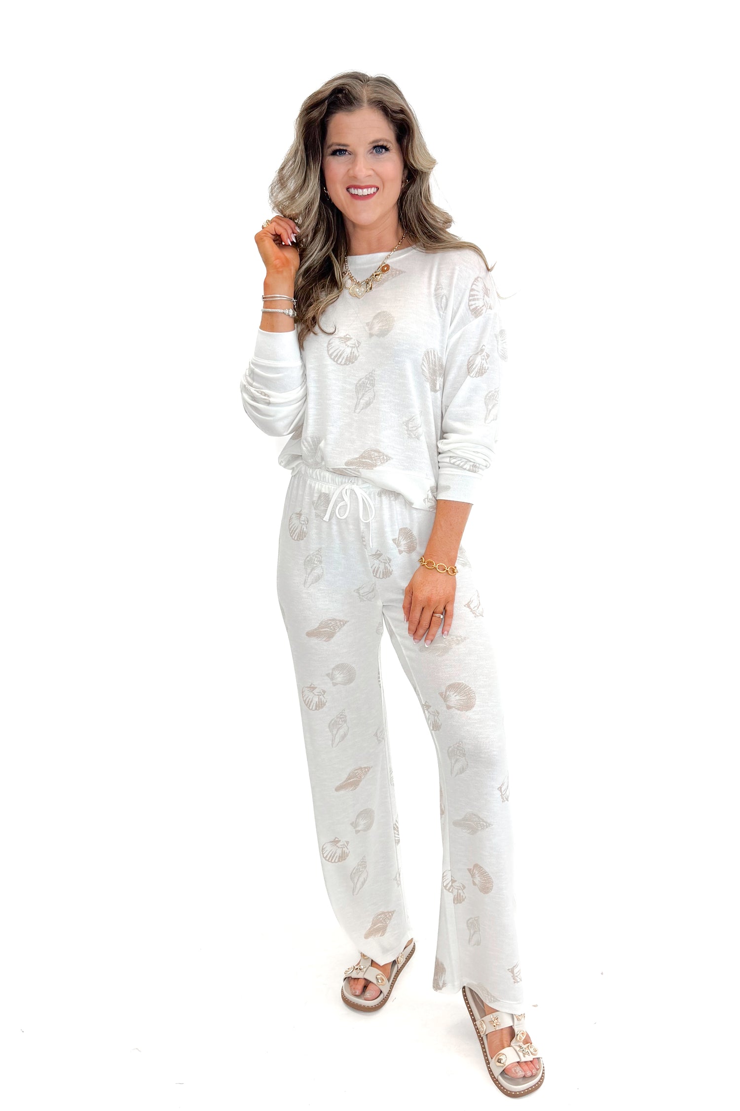 Front view of woman wearing Vanilla Ice So Sweet Shell Pants by Z Supply with matching top against white studio background.