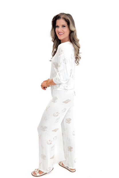 Side view of woman wearing Vanilla Ice So Sweet Shell Pants by Z Supply with matching top against white studio background.