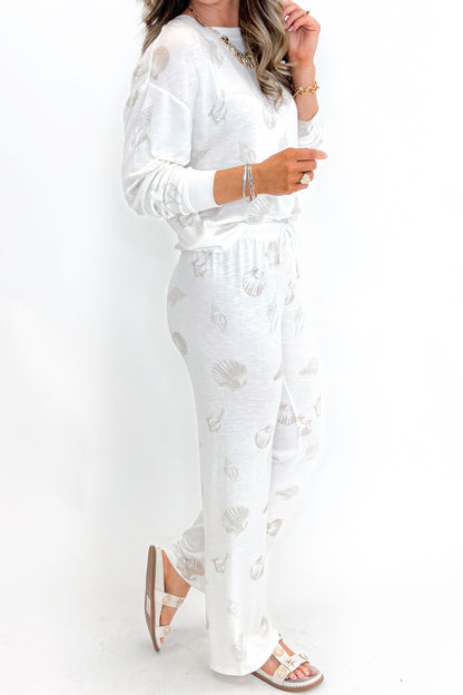 Side view of woman wearing Vanilla Ice So Sweet Shell Pants by Z Supply with matching top against white studio background.
