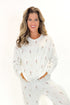 Front view of woman wearing Vanilla Ice Champagne Long Sleeve Top with matching pants against white studio background.