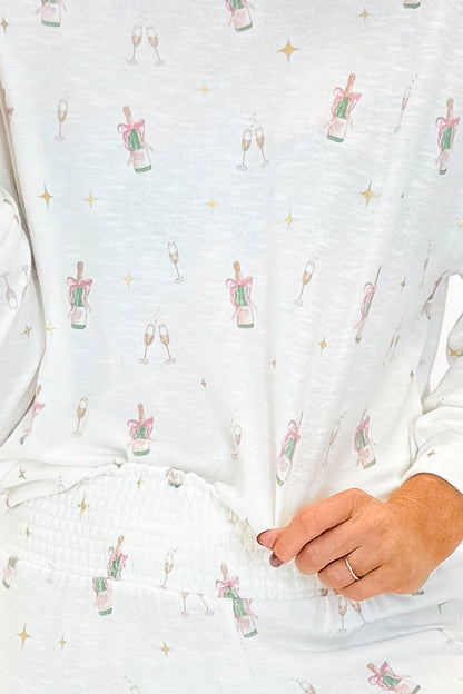 Detailed view of woman wearing Vanilla Ice Champagne Long Sleeve Top with matching pants against white studio background.