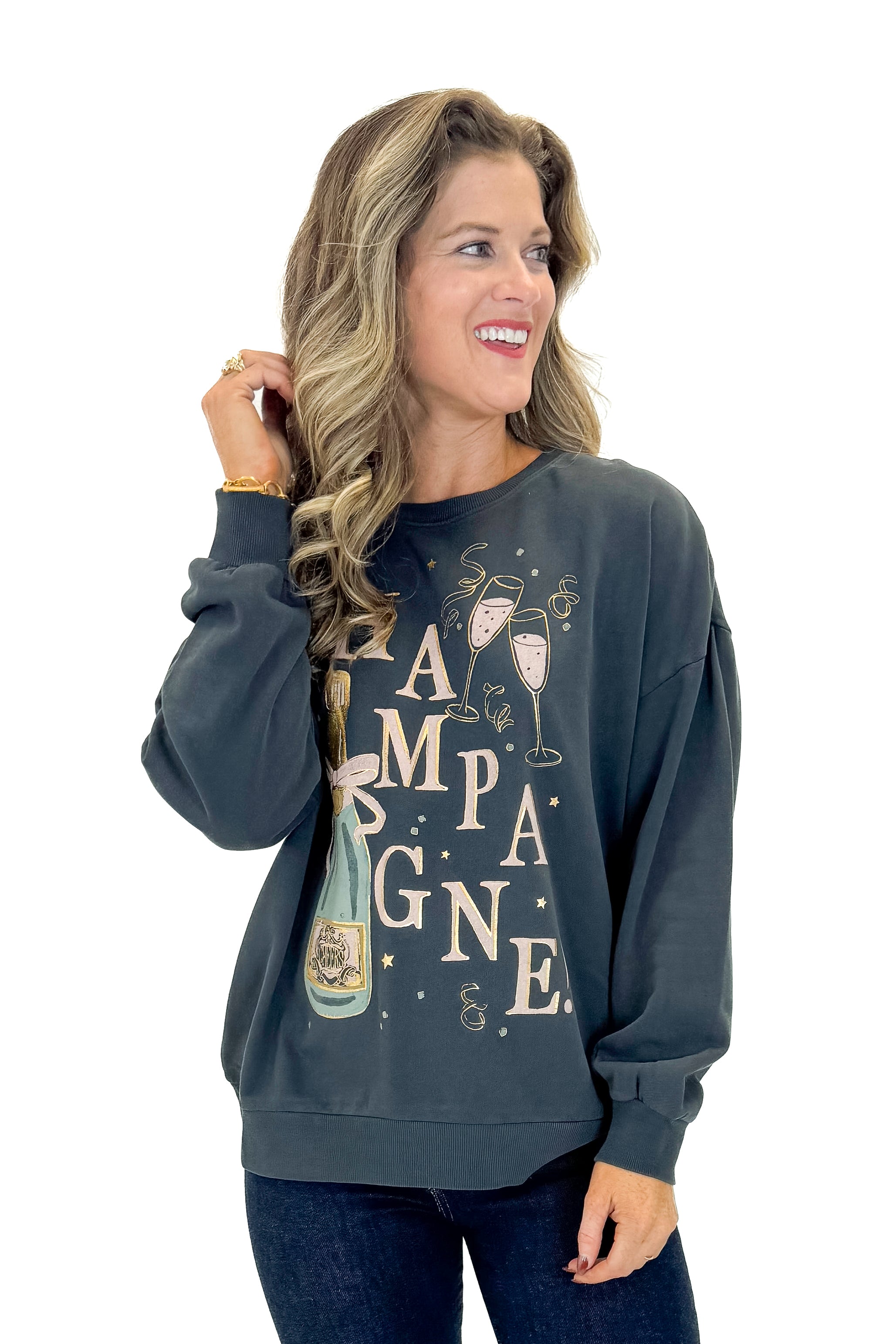 Front view of woman wearing Black Celebrate Sunday Sweatshirt with jeans against white studio background.