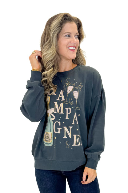 Front view of woman wearing Black Celebrate Sunday Sweatshirt with jeans against white studio background.