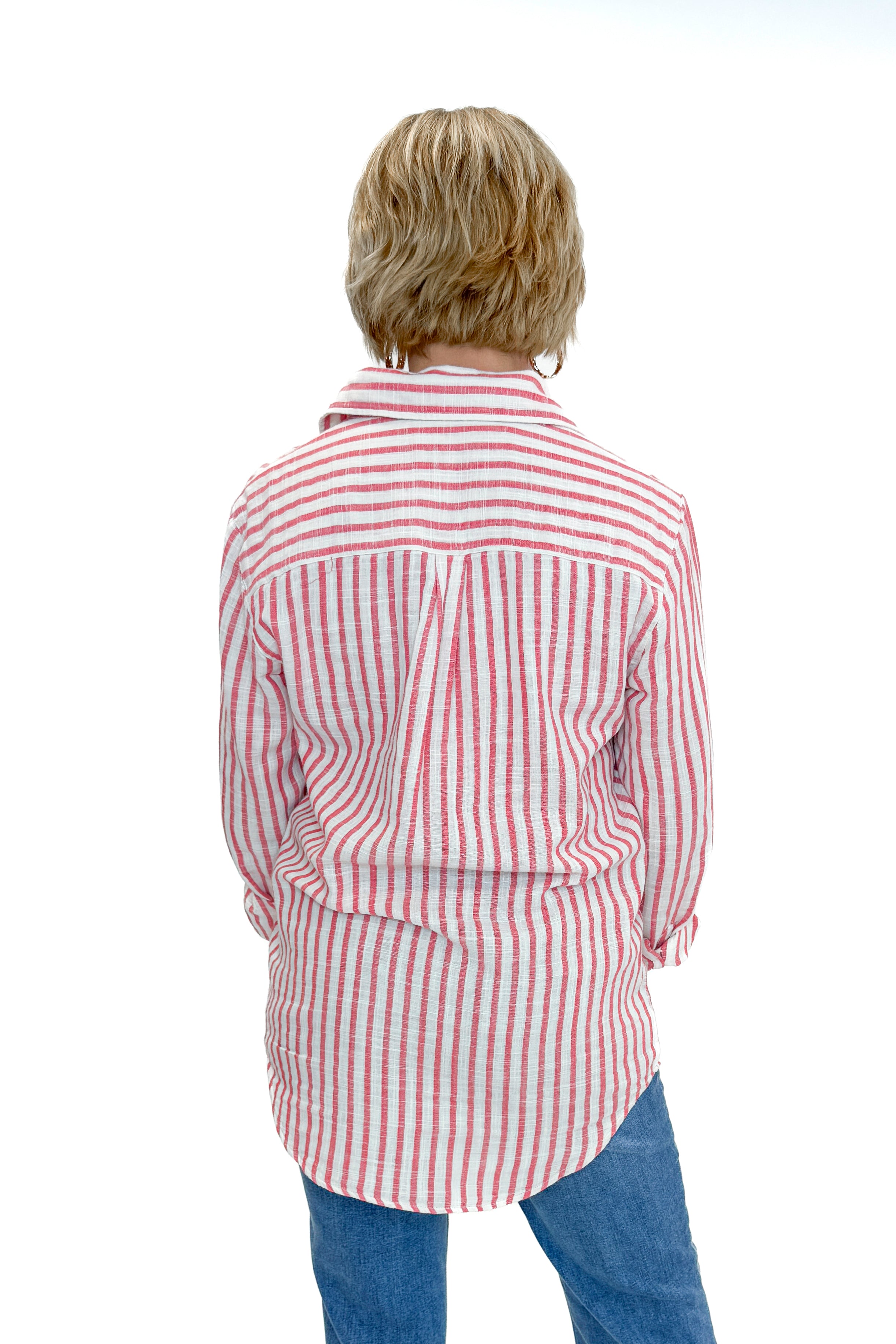 Back view of woman wearing Crimson Crush Saturdays Stripe Shirt by Z Supply with jeans against white studio background.