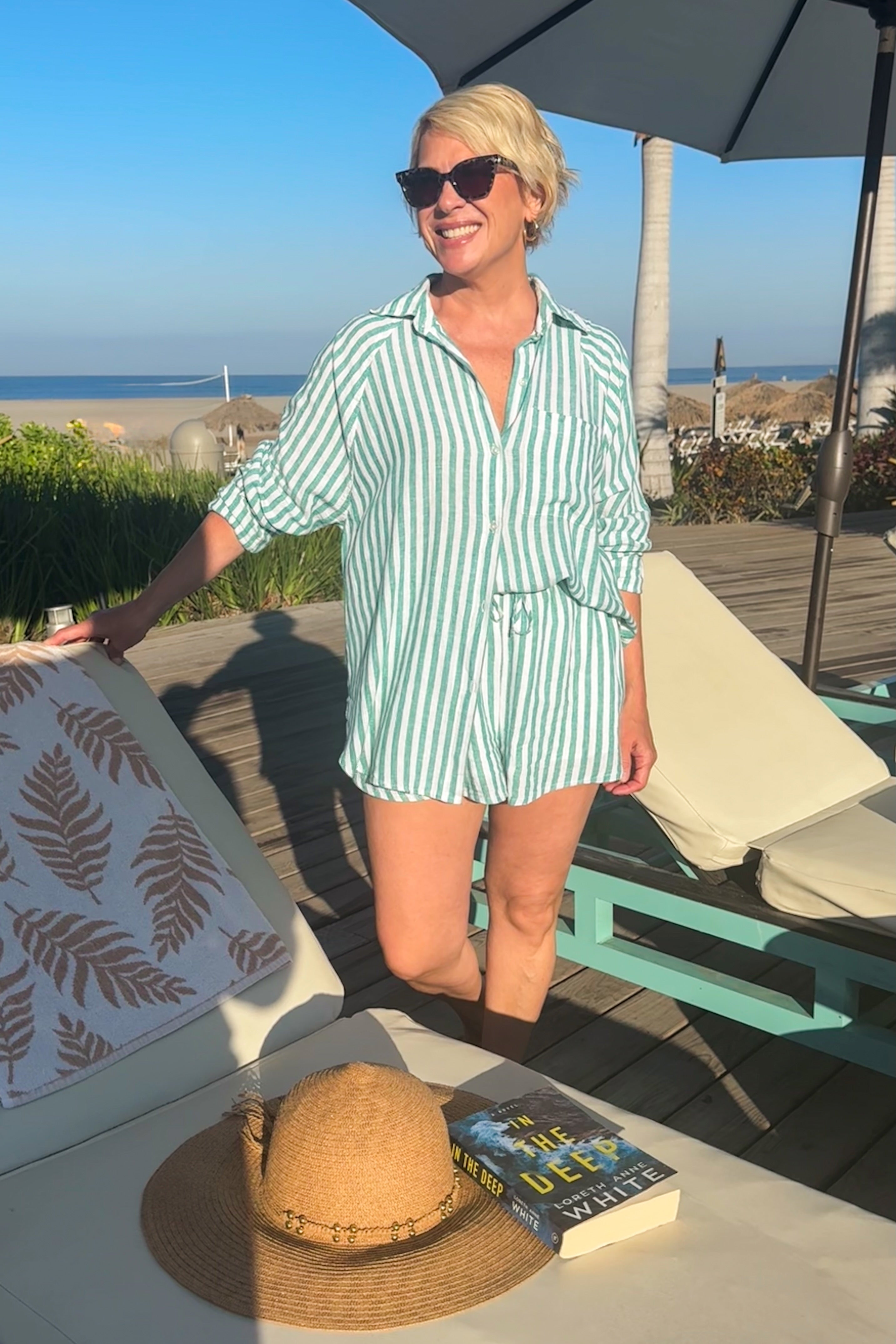 Front view of woman wearing La Palma Perfect Line Shorts by Z Supply with matching top outside at the beach.