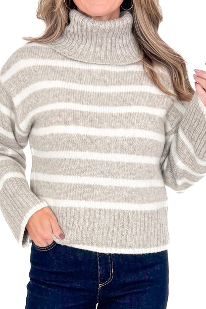 Front detailed view of woman wearing Z Supply stripe Josephine sweater with jeans against white studio background.