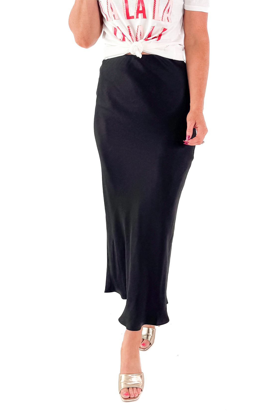 Front view of woman wearing t-shirt and black skirt by Z Supply against white studio background.