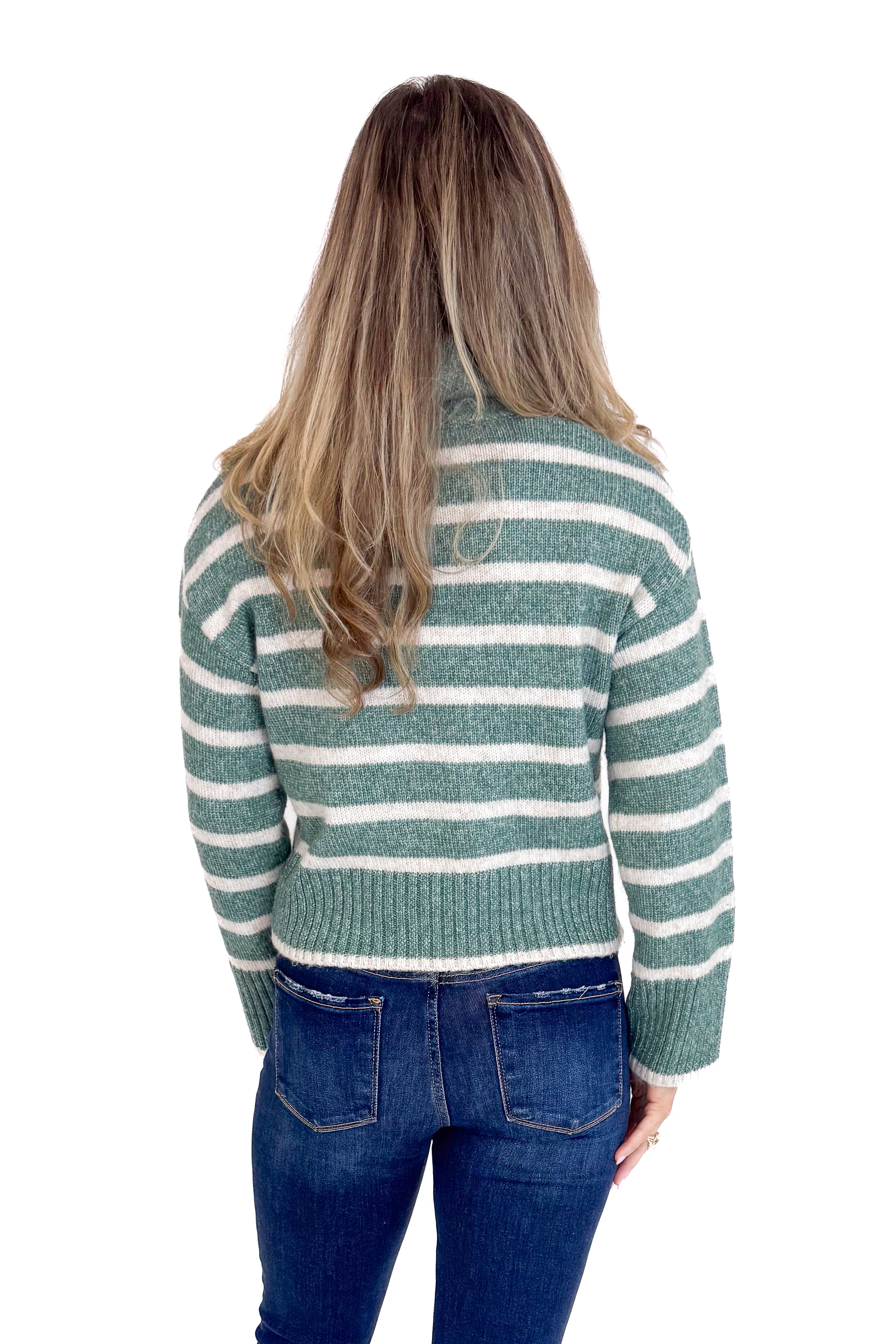 Person wearing a striped sweater and jeans from behind on a white background