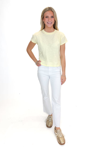 Front view of woman wearing Pineapple Modern Slub Tee by Z Supply with jeans against white studio background.