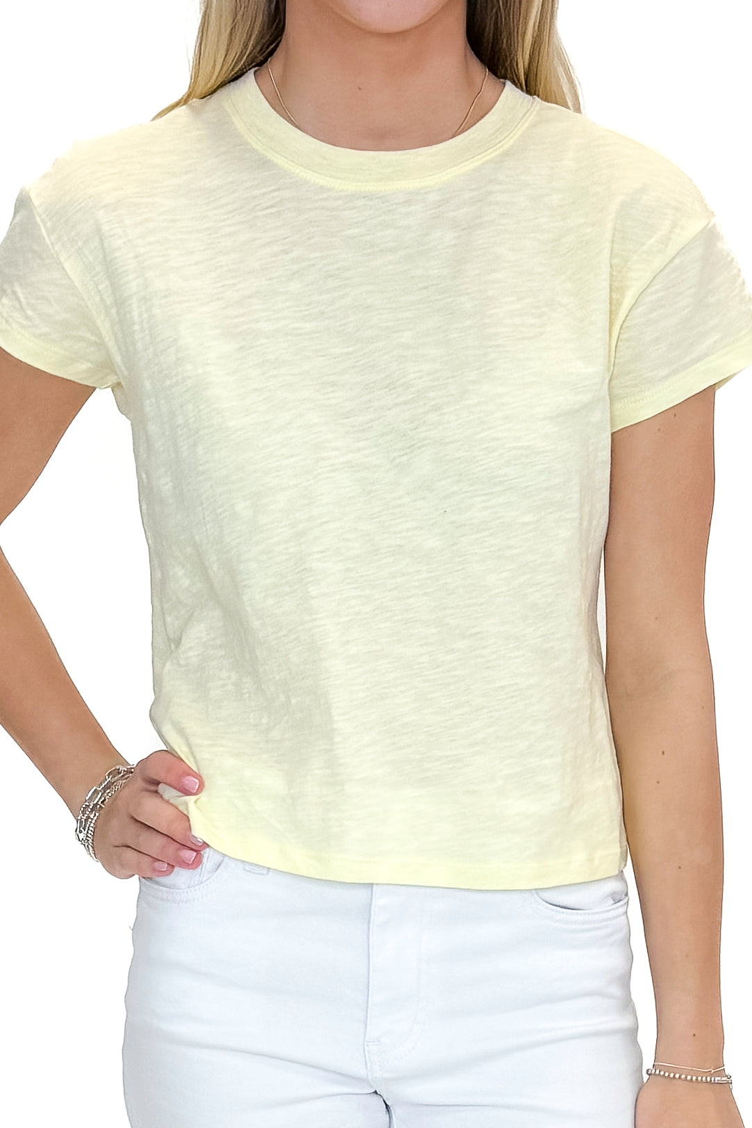 Front detail view of woman wearing Pineapple Modern Slub Tee by Z Supply with jeans against white studio background.