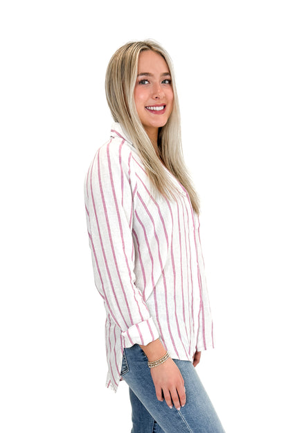 Side view of woman wearing The Perfect Line Top In Spanish Rose by Z Supply with jeans against white studio background.
