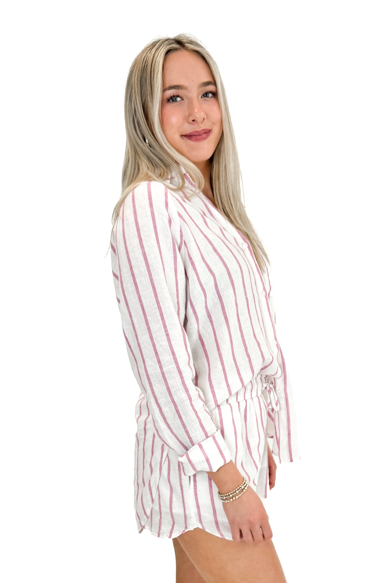 Side view of woman wearing The Perfect Line Top In Spanish Rose by Z Supply with matching shorts against white studio background.