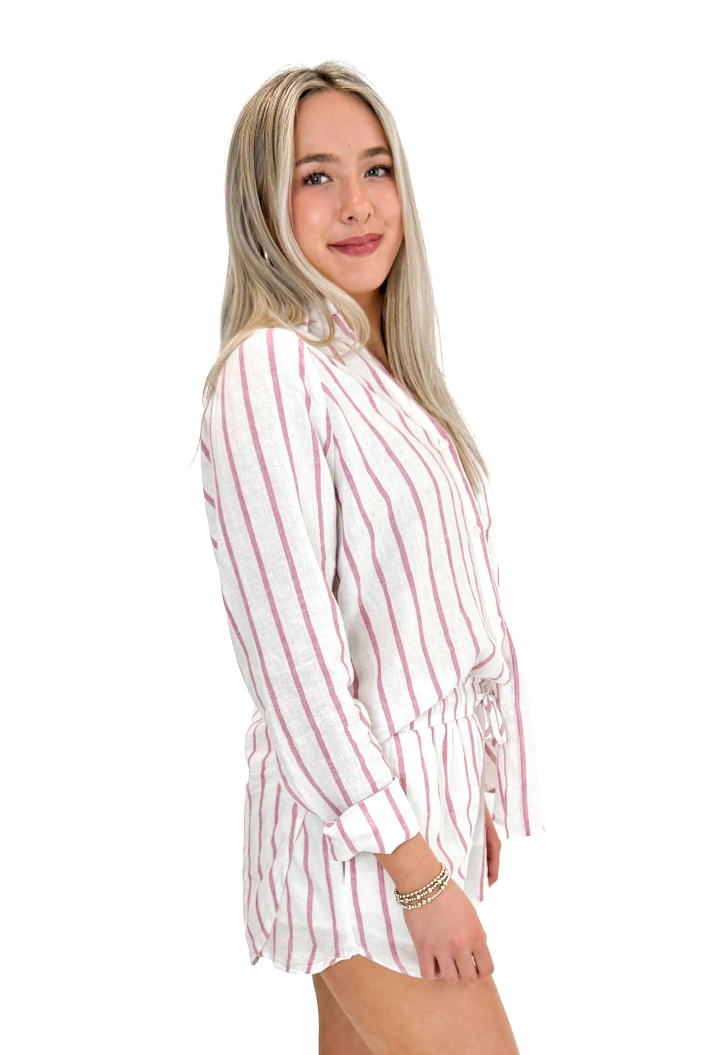 Side view of woman wearing The Perfect Line Top In Spanish Rose by Z Supply with matching shorts against white studio background.
