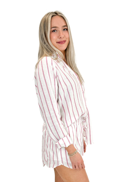 Side view of woman wearing The Perfect Line Top In Spanish Rose by Z Supply with matching shorts against white studio background.