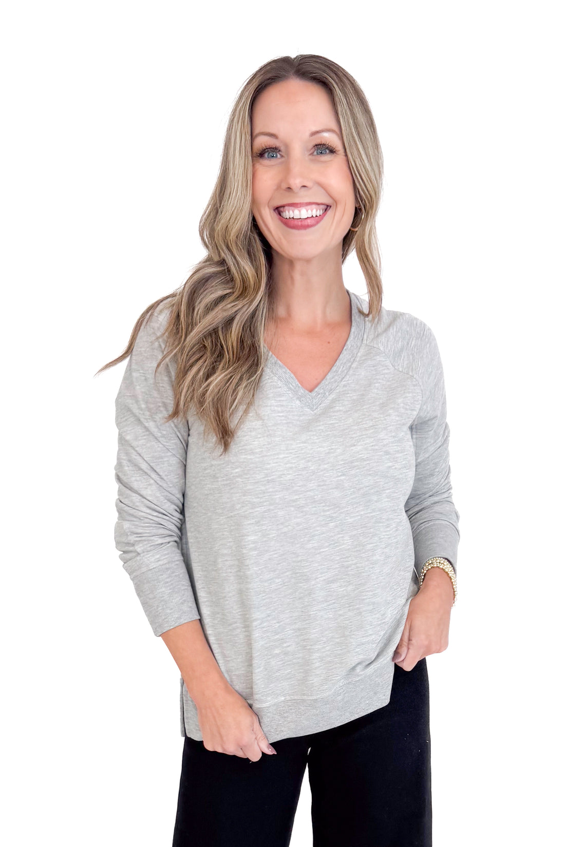 Woman wearing a gray sweater on a white background