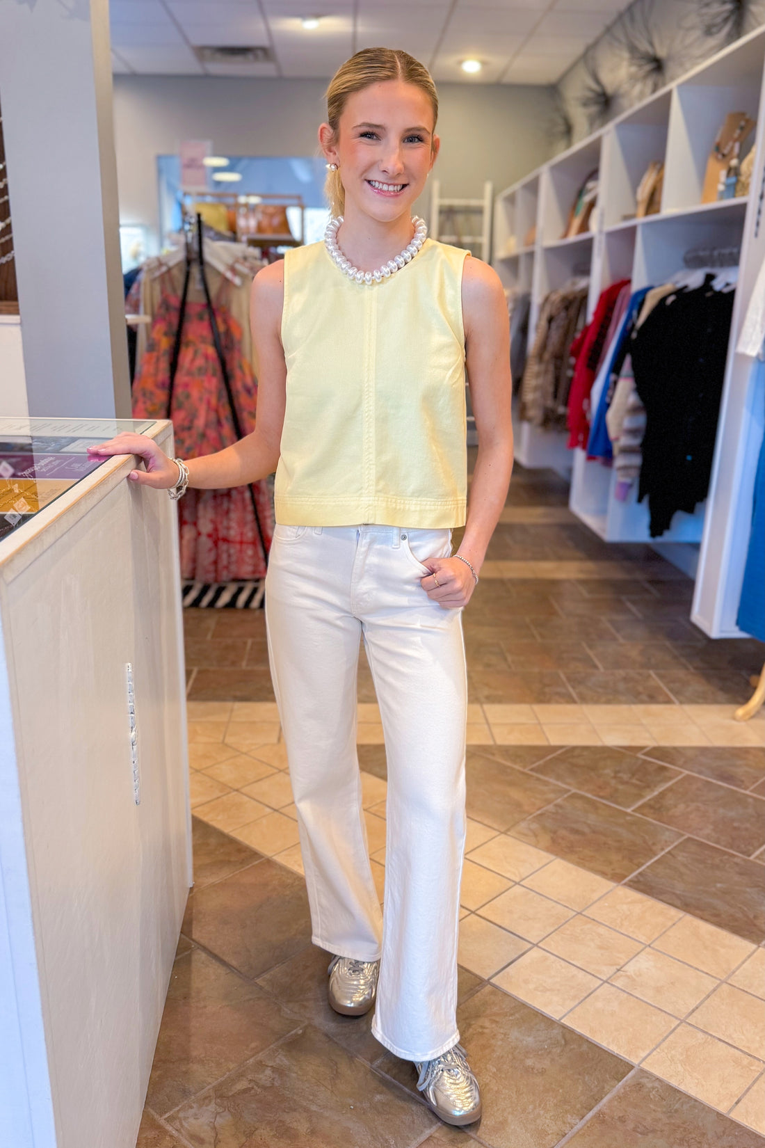 Front view of woman wearing Sunnyside Sun Seeker Tank by Z Supply with jeans at a boutique.