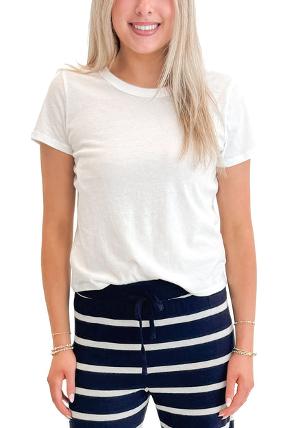 Front detail view of woman wearing White Junie Tee Shirt by Z Supply with pants against white studio background.