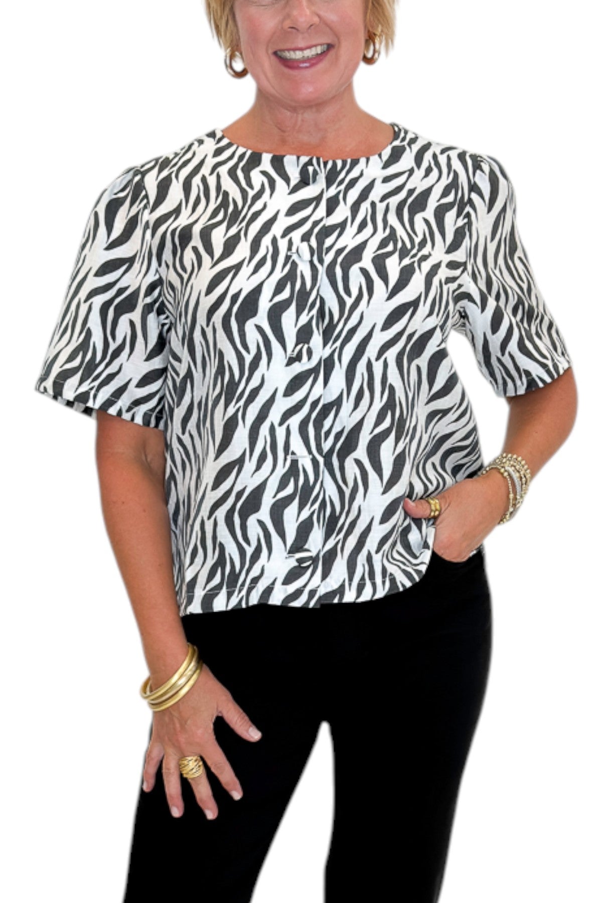 Front detail view of woman wearing Swagger Boutique’s Zebra Print Button Down Top with jeans against white studio background.