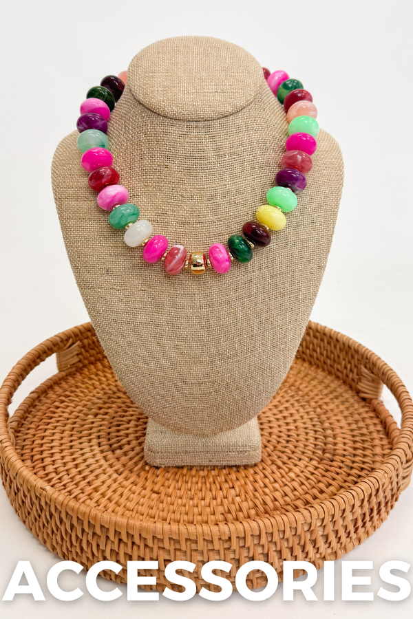 Colorful beaded necklace on a tan mannequin bust with 'ACCESSORIES' text below.