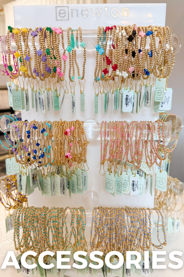 enewton bracelets on a display spinner with "accessories" text overlay