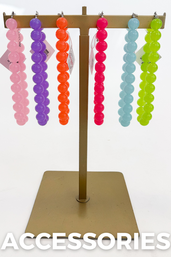 Colorful beaded necklaces on a stand with 'ACCESSORIES' text below.