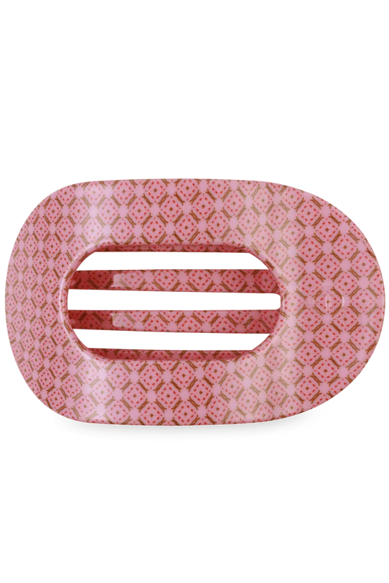 Decorative pink barrette with a white background