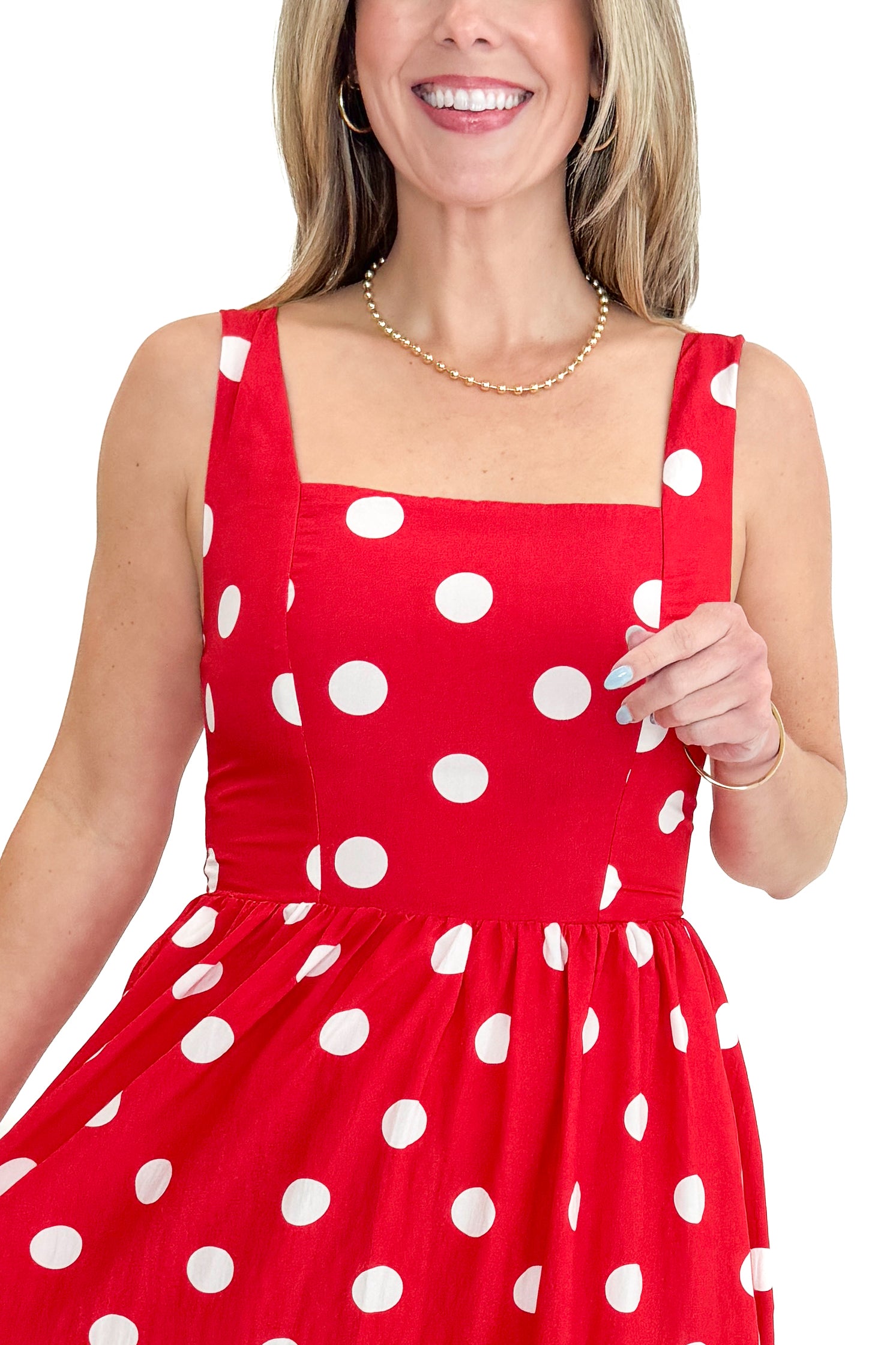 Front detail view of woman wearing Red &amp; White Polka Dot Midi Dress against white studio background.