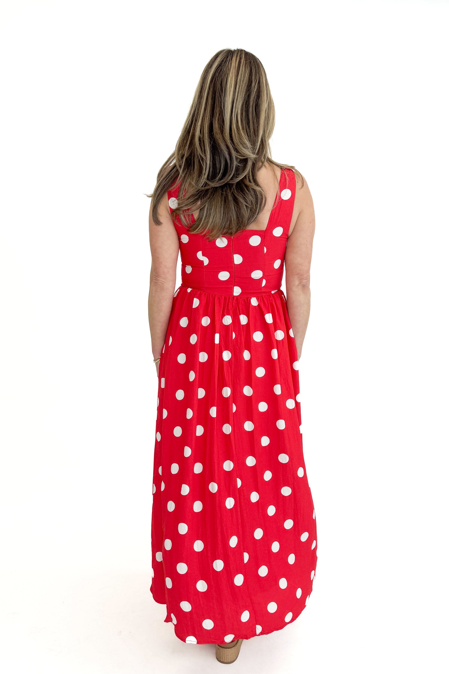 Back view of woman wearing Red &amp; White Polka Dot Midi Dress against white studio background.