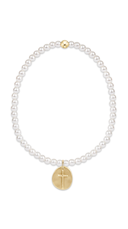 A delicate beaded bracelet featuring pearls and a small gold cross charm shown on a plain white background.