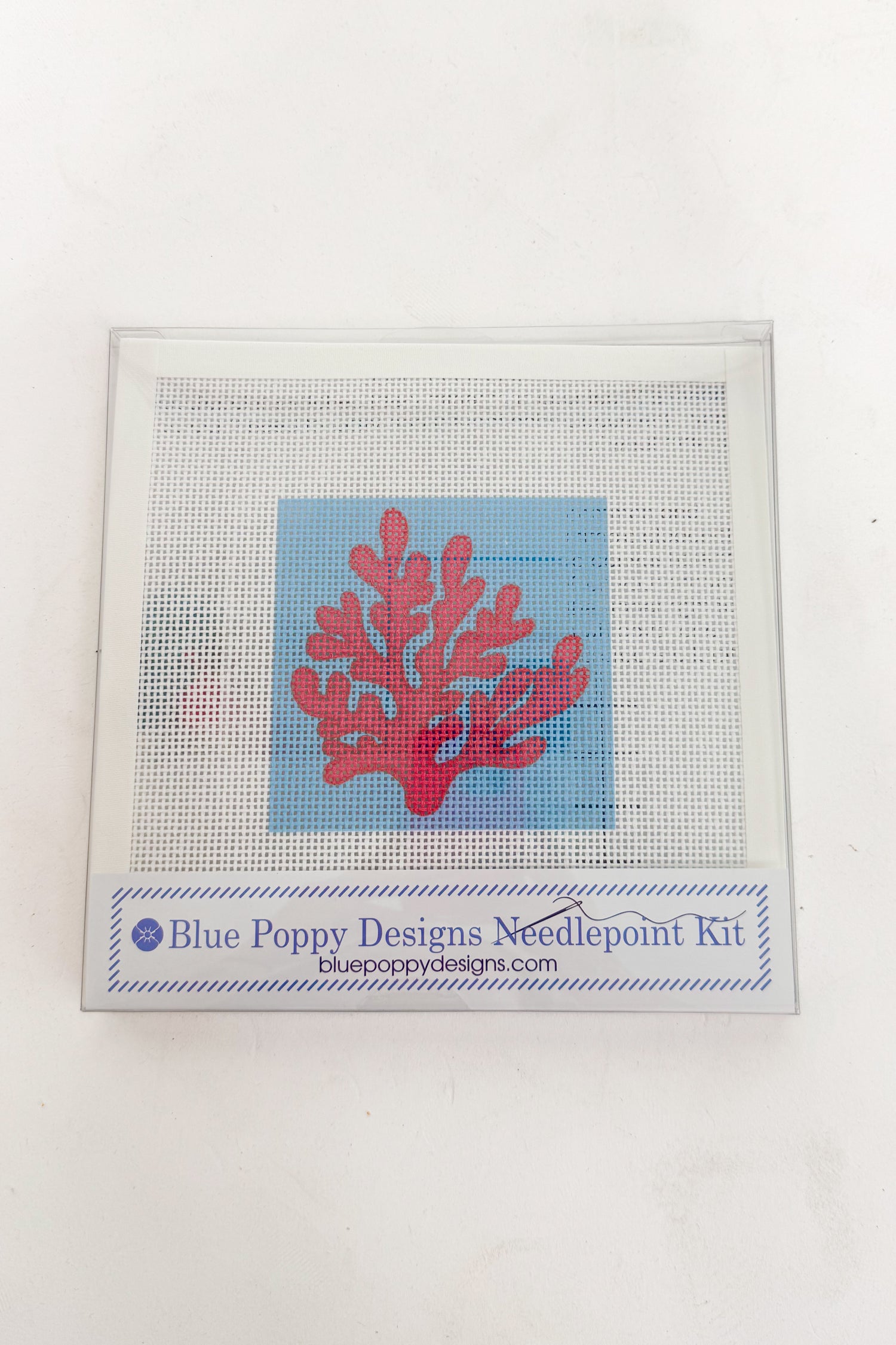 Needlepoint kit with red coral design on a white background