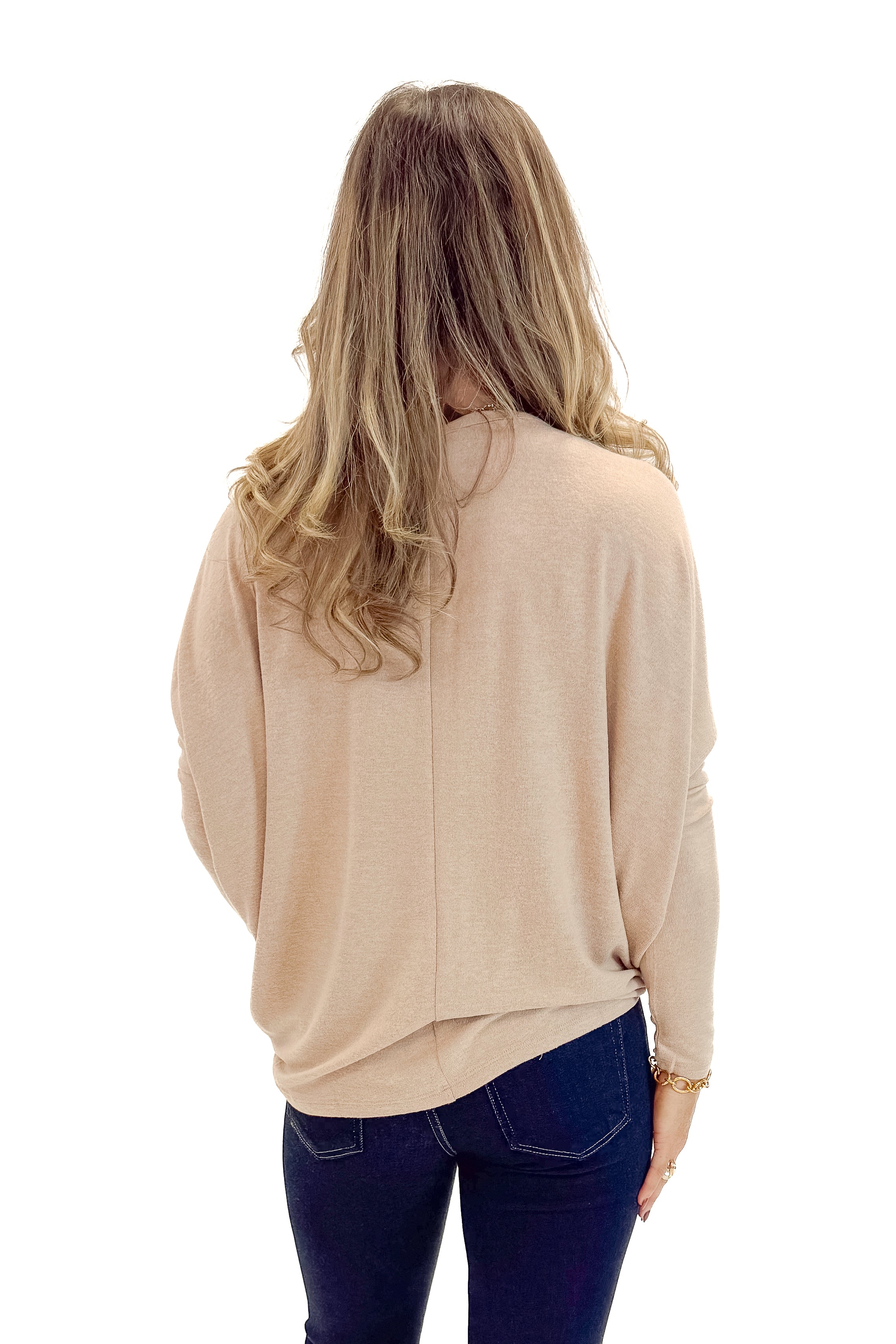 Back view of woman wearing Taupe Dolman Sleeve Top with jeans against white studio background.