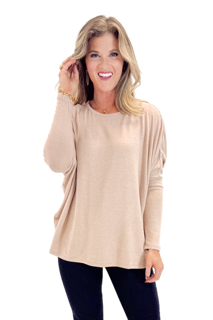 Front view of woman wearing Taupe Dolman Sleeve Top with jeans against white studio background.