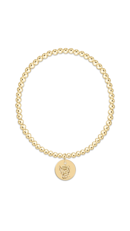 A gold beaded stretch bracelet with a circular medallion charm featuring an nc state mascot, displayed on a clean white background.