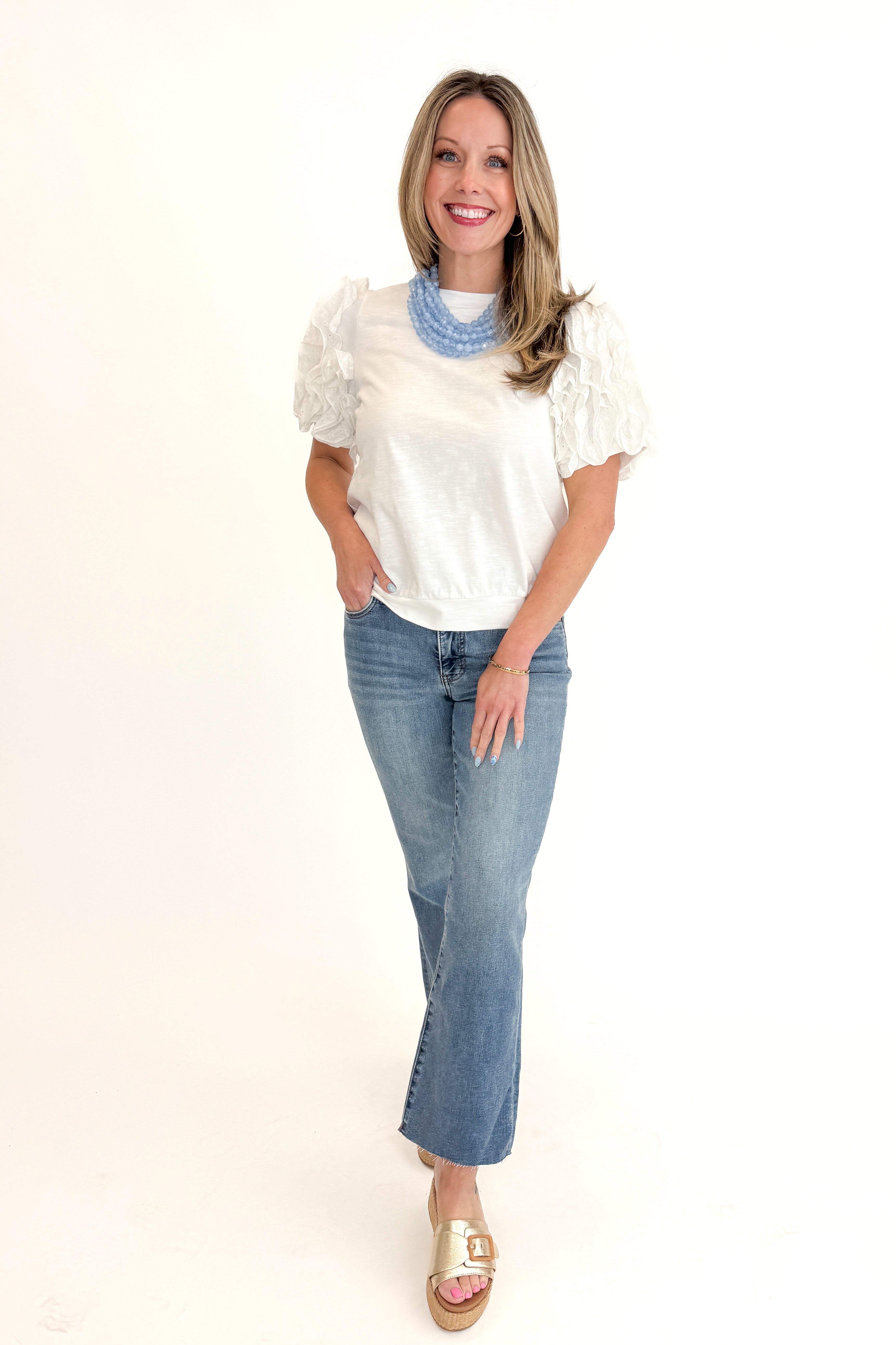 Front view of woman wearing White Ruffle Sleeve Detail Top by Fate with jeans against white studio background.