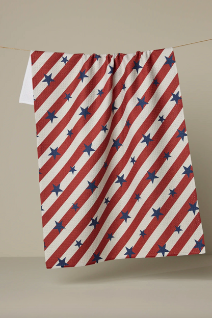 Red, white, and blue striped towel with star pattern on a beige background