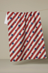Red, white, and blue striped towel with star pattern on a beige background