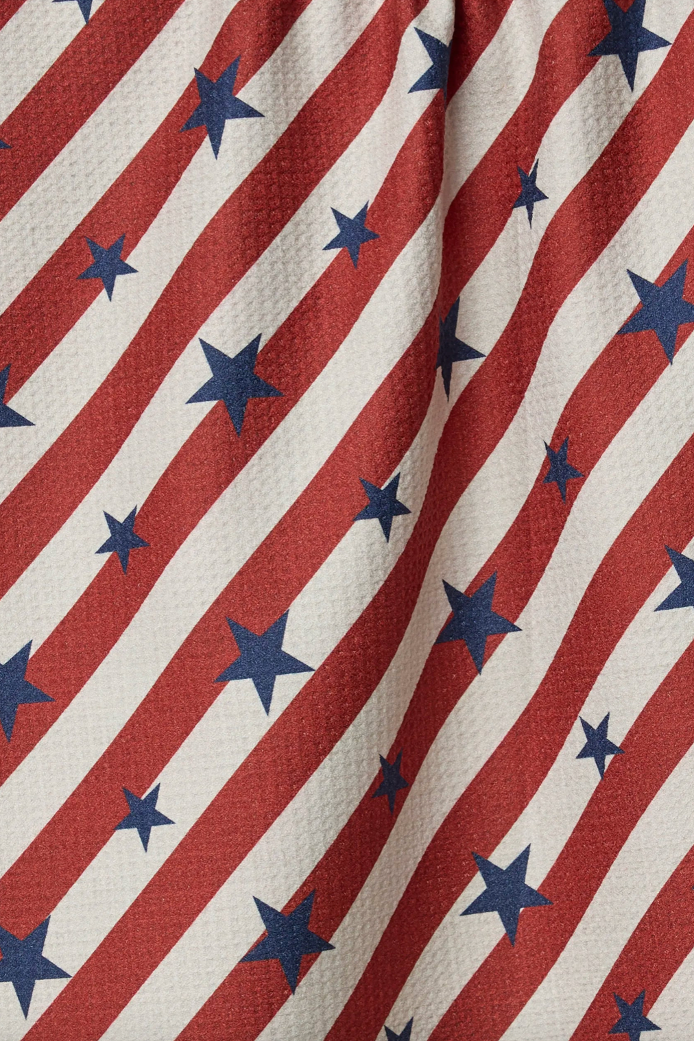 Fabric with red and white diagonal stripes and blue stars