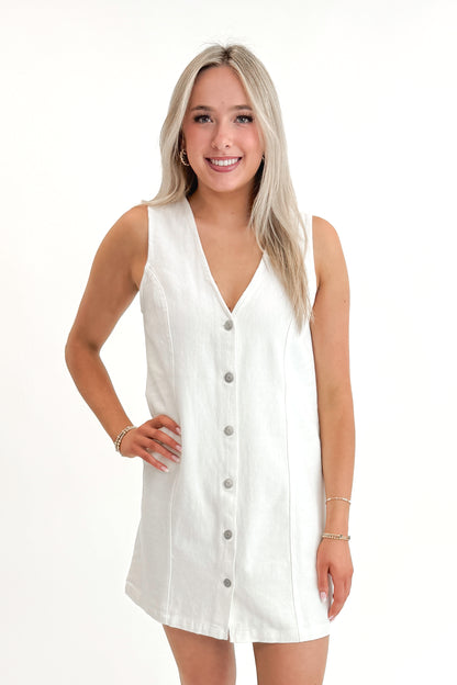Front view of woman wearing White Denim Button Up Dress against white studio background.