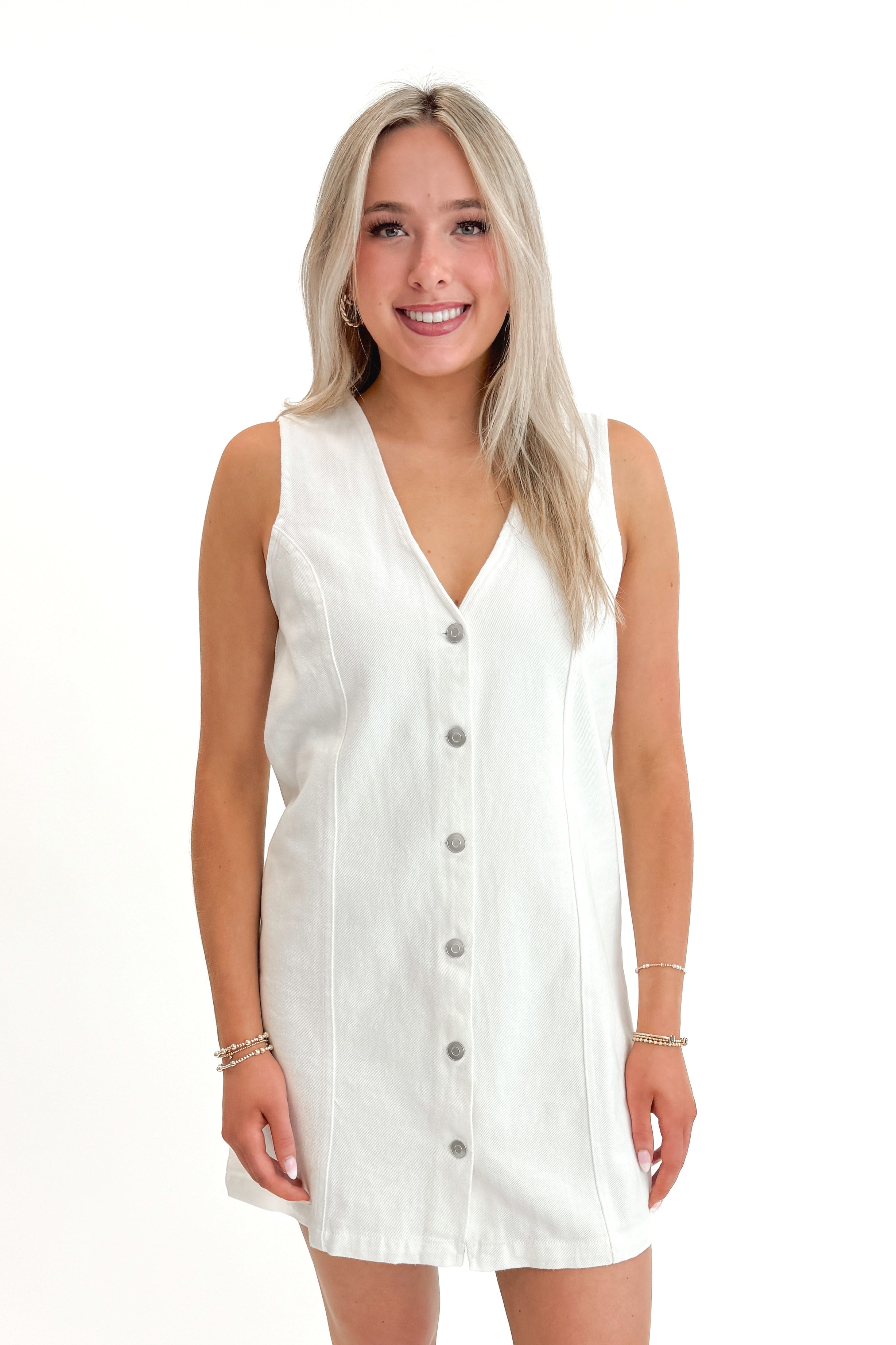 Front view of woman wearing White Denim Button Up Dress against white studio background.