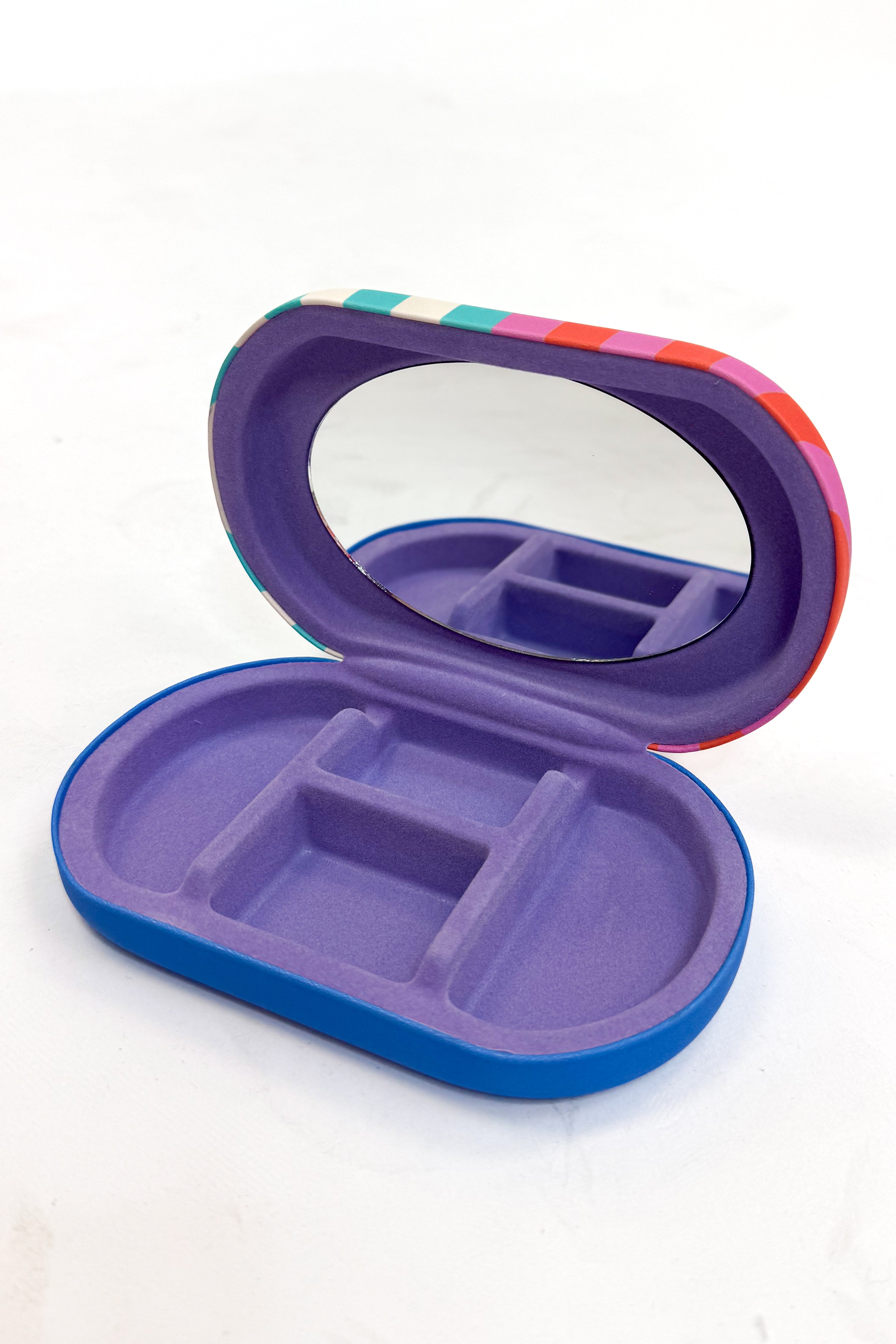 Purple and blue jewelry organizer with a mirror on a white background